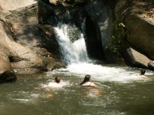Swimming at waterfall in the mountains of